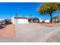 Updated single-story home with modern facade, landscaped yard, and gated driveway at 11252 N 37Th St, Phoenix, AZ 85028