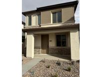 Two-story home with stone accents and a covered porch at 1223 W Sparrow Dr, Queen Creek, AZ 85140