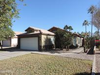 One-story house with a two-car garage and desert landscaping at 1435 S Spartan St, Gilbert, AZ 85233