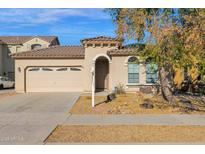 One-story house with a two-car garage and desert landscaping at 15466 W Laurel Ln, Surprise, AZ 85379