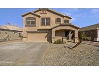 Two story house with tan exterior, double garage, and landscaped front yard at 1708 E Galveston St, Gilbert, AZ 85295