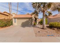 Tan two-story house with a brown tile roof, attached garage, and desert landscaping at 1740 W Del Rio St, Chandler, AZ 85224