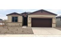 Single-story home with brown garage door and landscaping at 19021 W Rose Ln, Waddell, AZ 85355