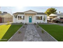 Newly renovated home with artificial turf and a herringbone walkway at 3850 N 12Th Ave, Phoenix, AZ 85013