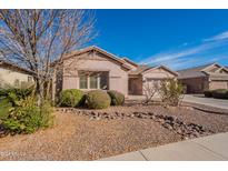 House exterior with landscaping and a long driveway at 44562 W Sedona Trl, Maricopa, AZ 85139