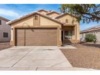 Beige house with brown garage door and gravel driveway at 6538 W Nez Perce St, Phoenix, AZ 85043