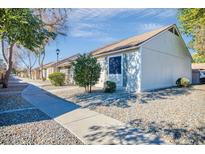 Attractive exterior of a condo building with a walkway and landscaping at 8901 W Loma Ln, Peoria, AZ 85345