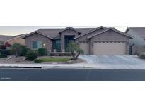 Single-story home with neutral exterior, landscaped yard, and two-car garage at 11063 E Ocaso Ave, Mesa, AZ 85212