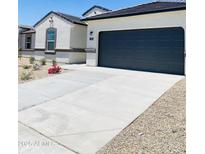 New single-story home with a two-car garage and landscaped front yard at 1130 W Avalon Canyon Dr, Casa Grande, AZ 85122