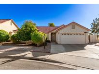 Single-story home with red tile roof, two-car garage, and mature landscaping at 1201 E Campbell Ave, Gilbert, AZ 85234