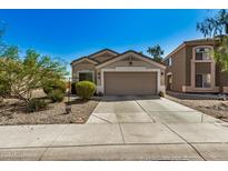 Tan house with a two-car garage and well-maintained landscaping at 12443 W Via Camille Dr, El Mirage, AZ 85335