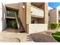 Exterior view of condo building showing stairs and landscaping at 1295 N Ash St # 913, Gilbert, AZ 85233