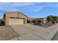 House exterior featuring a two-car garage and desert landscaping at 15158 W Camino Estrella Dr, Surprise, AZ 85374