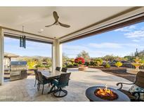 Covered patio with built-in grill, fire pit, and mountain views at 17817 E Cindercone Rd, Rio Verde, AZ 85263