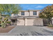 Two-story house with beige exterior, two-car garage, and mature landscaping at 2542 W Kit Carson Trl, Phoenix, AZ 85086