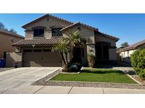 Two-story house with brown stucco, tile roof, and landscaped front yard at 3610 N 106Th Ave, Avondale, AZ 85392