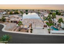 Stunning aerial view of a waterfront home with pool and lush landscaping at 5287 W Quail Ave, Glendale, AZ 85308