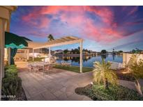 Lakefront patio with pergola, outdoor furniture, and serene views at 5287 W Quail Ave, Glendale, AZ 85308