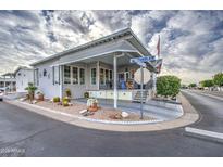 Inviting exterior of a manufactured home with landscaped yard and covered porch at 7750 E Broadway Rd # 584, Mesa, AZ 85208