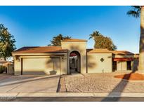 Single-story home with arched entryway and terracotta tile roof at 10302 E Lotus Ct, Chandler, AZ 85248