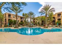 Inviting community pool with palm trees and lounge chairs at 11640 N Tatum Blvd # 2079, Phoenix, AZ 85028