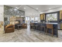 Gourmet kitchen with island, fireplace, and modern appliances at 15831 E Thistle Dr, Fountain Hills, AZ 85268