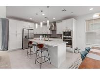 Spacious kitchen featuring white cabinets and a large island at 1685 S Wallrade Ln, Gilbert, AZ 85295