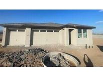 New construction home with attached two-car garage and desert landscaping at 19008 W Stella Ave, Waddell, AZ 85355