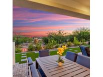 Relaxing backyard patio with seating area and artificial turf at 20363 W Coolidge St, Buckeye, AZ 85396