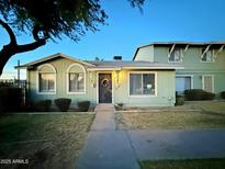 Charming light green single story home with a well manicured lawn at 2645 W Wolf St, Phoenix, AZ 85017