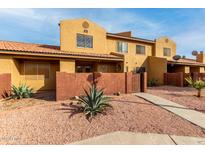 Two-story stucco home with a gated entrance and desert landscaping at 3511 E Baseline Rd # 1203, Phoenix, AZ 85042