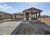 New single-story home with stone accents and a two-car garage at 37551 W Patterson St, Maricopa, AZ 85138