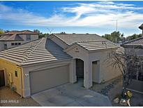 Single-story home with tile roof, two-car garage, and desert landscaping at 4119 E Barwick Dr, Cave Creek, AZ 85331