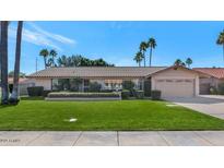 Single-story home with a well-manicured lawn and attached garage at 437 E Marconi Ave, Phoenix, AZ 85022