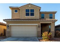 Two-story house with beige exterior, two-car garage, and landscaping at 5656 N 109Th Ave, Phoenix, AZ 85037