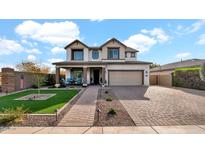 Two-story house with landscaped yard, large driveway and neutral color scheme at 7563 E Plata Ave, Mesa, AZ 85212