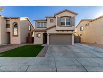 Two-story house with a gray garage door and artificial turf at 9823 E Escondido Ave, Mesa, AZ 85208