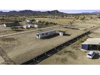 Expansive lot featuring a charming single-story home with metal roof and convenient outdoor storage at 6326 N Deer Trl, Maricopa, AZ 85139