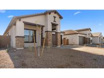 New construction home with stone accents and a 2-car garage at 685 E Greenback Dr, San Tan Valley, AZ 85140