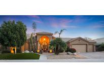 Beautiful desert home with a landscaped front yard, large garage, and inviting entryway at 9353 N 113Th Way, Scottsdale, AZ 85259