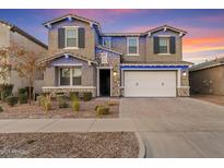 Two-story house with white garage door and landscaping at 9540 E Spiral Ave, Mesa, AZ 85212