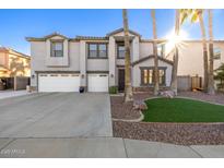 Two-story house with three-car garage and landscaped front yard at 10617 W Adela Dr, Peoria, AZ 85383