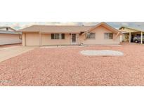 Ranch style home with a large front yard and a two-car garage at 11440 N Hagen Dr, Sun City, AZ 85351