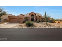 Beautiful desert landscape surrounds this two-story home with a three-car garage at 12605 E Kalil Dr, Scottsdale, AZ 85259