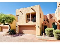 Front view of a two-story stucco home with a two-car garage and desert landscaping at 13227 N Mimosa Dr # 117, Fountain Hills, AZ 85268