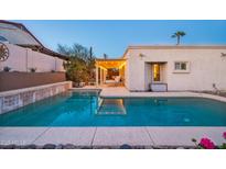 Inviting pool with a pergola and string lights; perfect for relaxing evenings at 15402 N 20Th St, Phoenix, AZ 85022