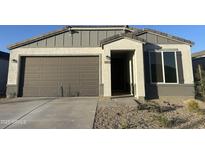 New single-story home with attached two-car garage and desert landscaping at 18070 W Cielo Grande Ave, Surprise, AZ 85387