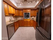 Modern kitchen with granite countertops and stainless steel appliances at 4200 N Miller Rd # 121, Scottsdale, AZ 85251