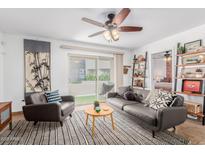 Living room with gray sofas and ceiling fan at 4444 E Paradise Village N Pkwy # 107, Phoenix, AZ 85032