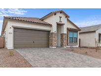 Craftsman style home with a two-car garage and stone accents at 671 E Greenback Dr, San Tan Valley, AZ 85140